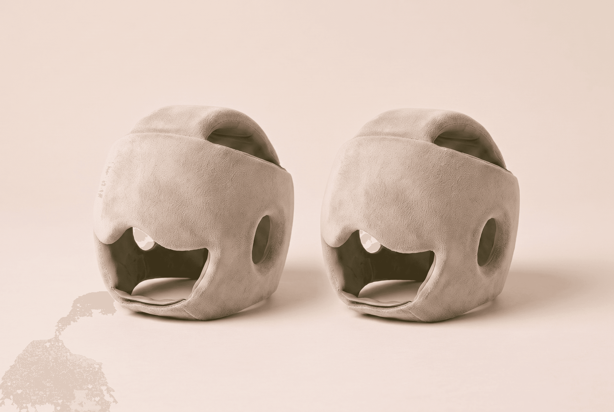 The Soothe Helmet 2-Pack — two matching oat-toned cooling caps with calm sage-green linings, side by side on a warm studio surface.